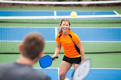 A couple playing pickleball.
