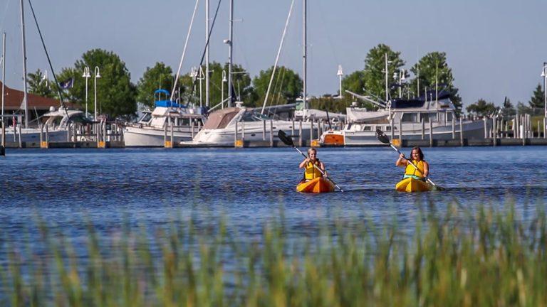 a pair of kayakers in the escanaba harbor
